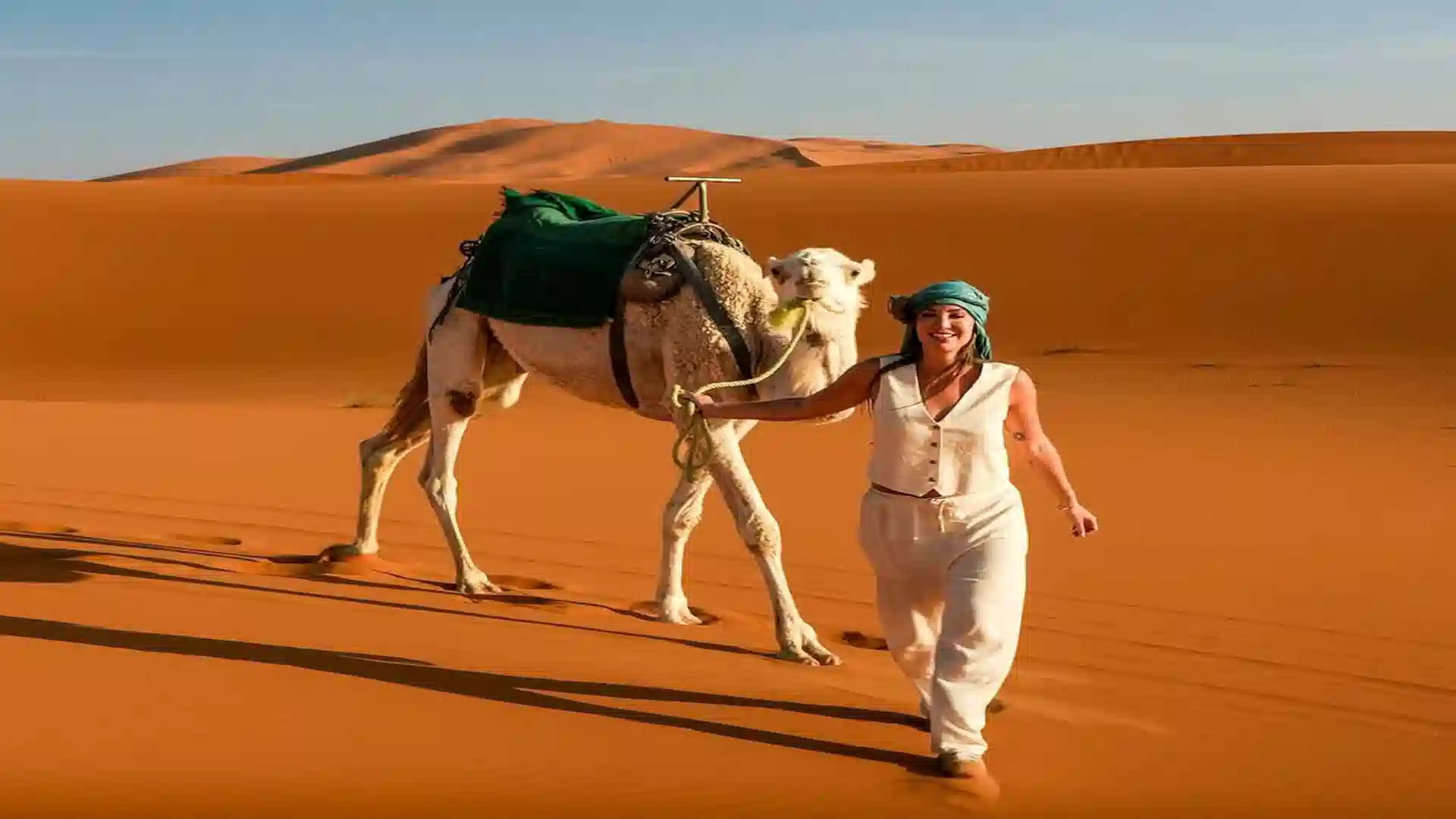 is Morocco safe to visit, Morocco travel advisory 2026 · Morocco safety for solo female travelers · Morocco tourist scams to avoid · is the Sahara desert safe in Morocco · Morocco health and safety tips Camel trekking in Merzouga — dromedary caravan crossing the Erg Chebbi dunes at sunset, Sahara Desert, Morocco